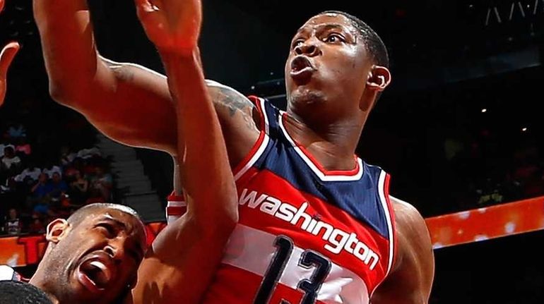 John Wall #2 and Kevin Seraphin #13 of the Washington...