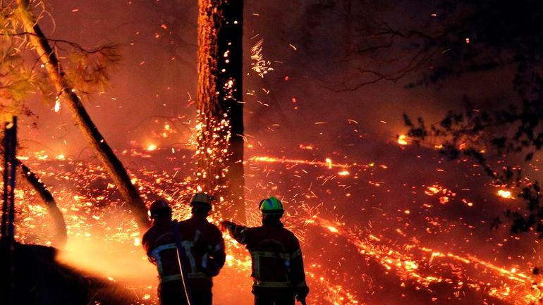 Firefighters battle a large fire at Chiberta forest in Anglet,...