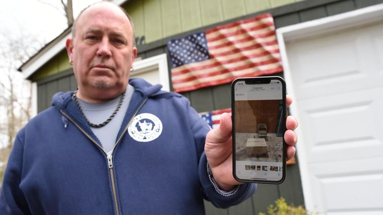 Edward Barnes, of Islip Terrace, holds a picture of the...