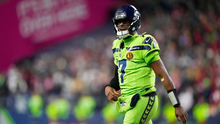 Seattle Seahawks quarterback Geno Smith (7) walks off the field...