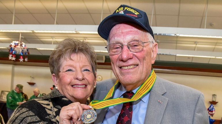 Peter Hanson, 76, with his wife Sherry, shows off a...