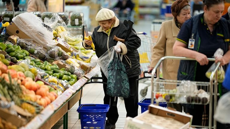 People buy fruits at a hypermarket in Moscow, Russia, on...