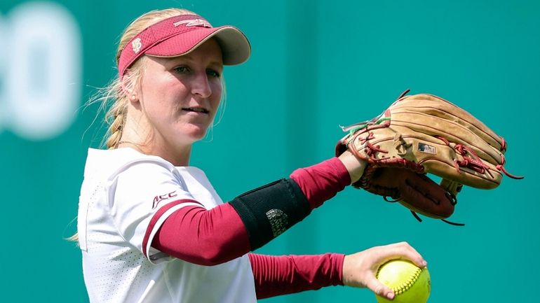 Florida State outfielder Kaley Mudge (6) warms up before an...