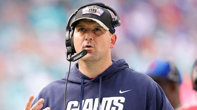 Giants head coach Joe Judge looks on from the sideline...