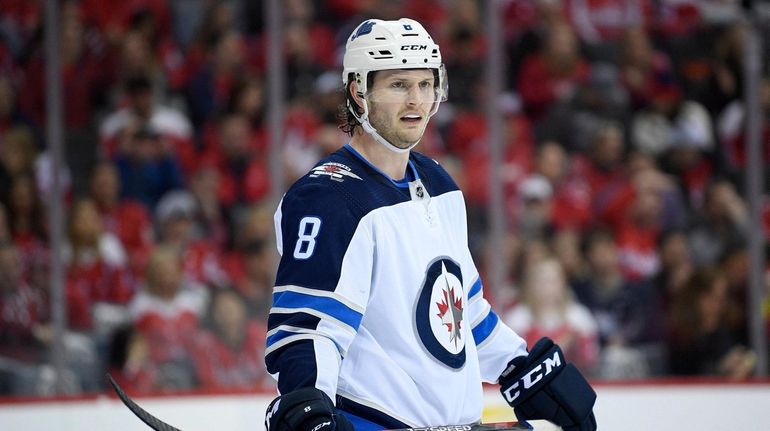 Jacob Trouba (8) stands on the ice during the first...