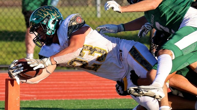 Ward Melville RB Nick Gaffney dives over the goal line...