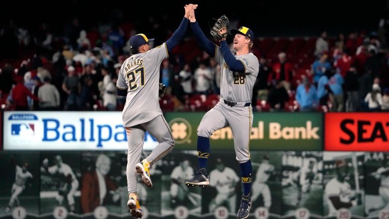 Milwaukee Brewers' Joey Wiemer (28) and Willy Adames (27) celebrate...