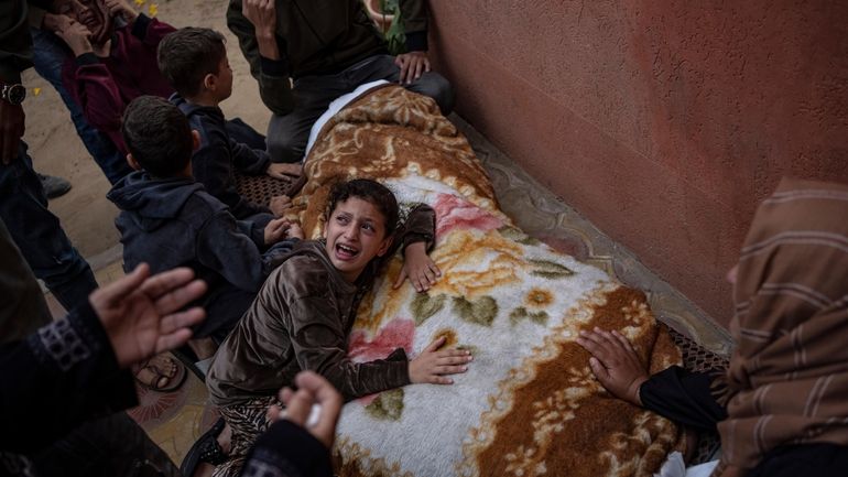 Palestinians mourn their relatives killed in the Israeli bombardment of...