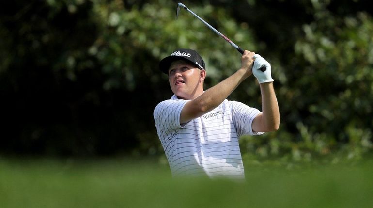 Zac Blai plays his tee shot on the par 3,...