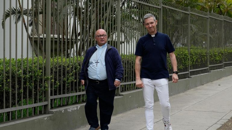 Vatican investigators Monsignor Jordi Bertomeu, right, from Spain, and Archbishop...