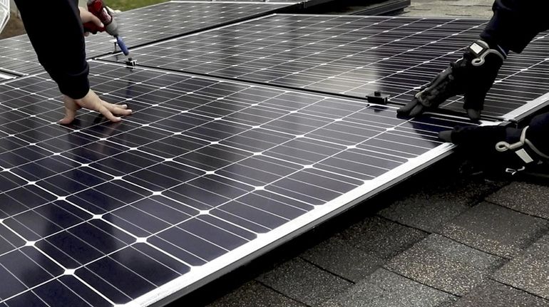 Solar panels are installed on the roof of a home...