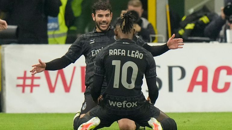 AC Milan's Theo Hernandez, right, celebrates with AC Milan's Rafael...