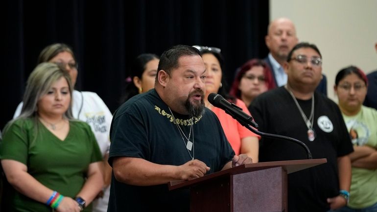 Javier Cazares, center, stands with families of the victims in...