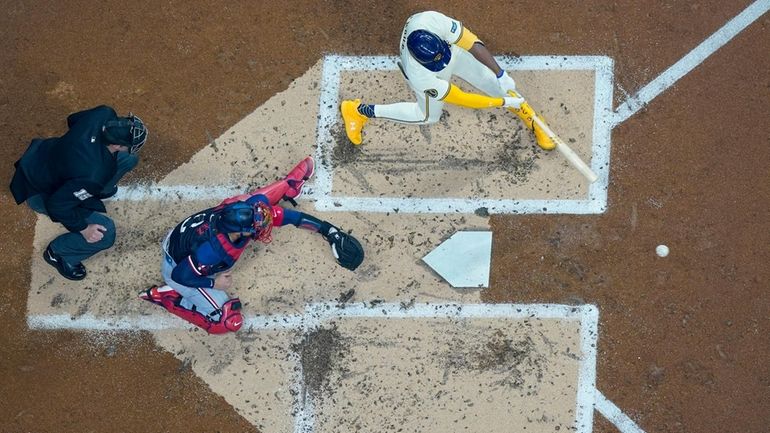 Milwaukee Brewers' Jackson Chourio hits an RBI single during the...