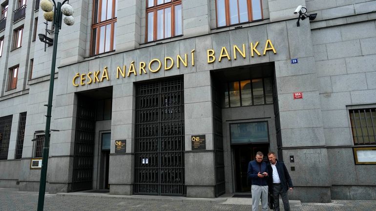 People stand outside the Czech central bank in Prague, Czech...