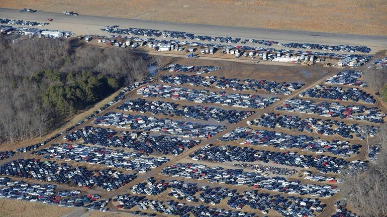 Vehicles that were damaged during superstorm Sandy are stored in...