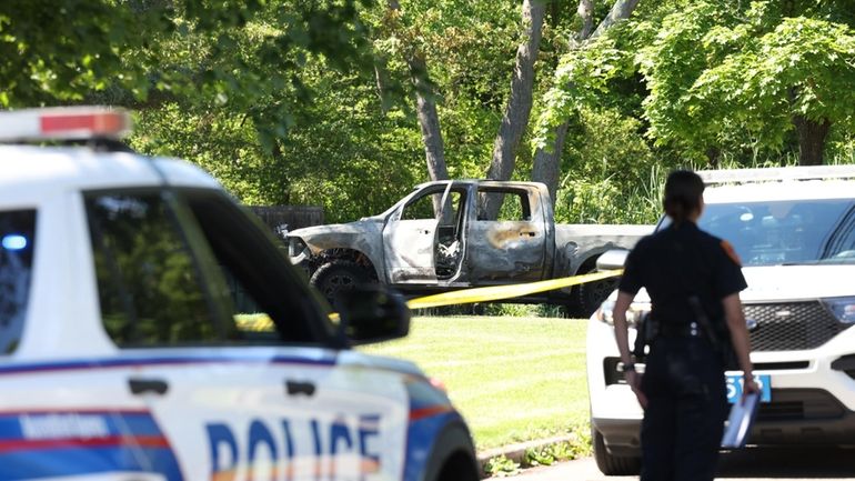 Suffolk County police respond to the scene of fire in a pickup truck...