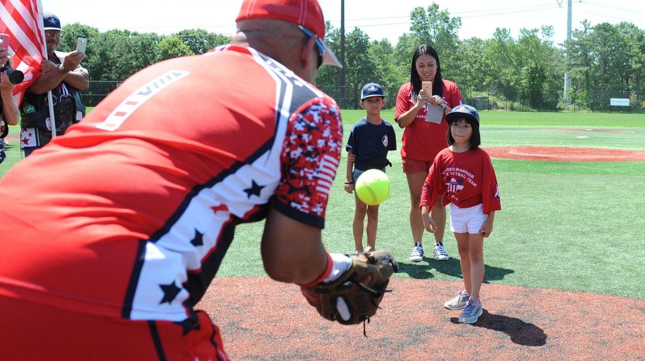 Softball players wears names of fallen veterans on team jerseys