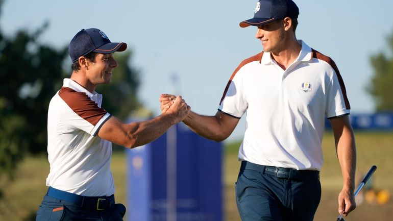 Europe's Ludvig Aberg, right, and playing partner Europe's Viktor Hovland...