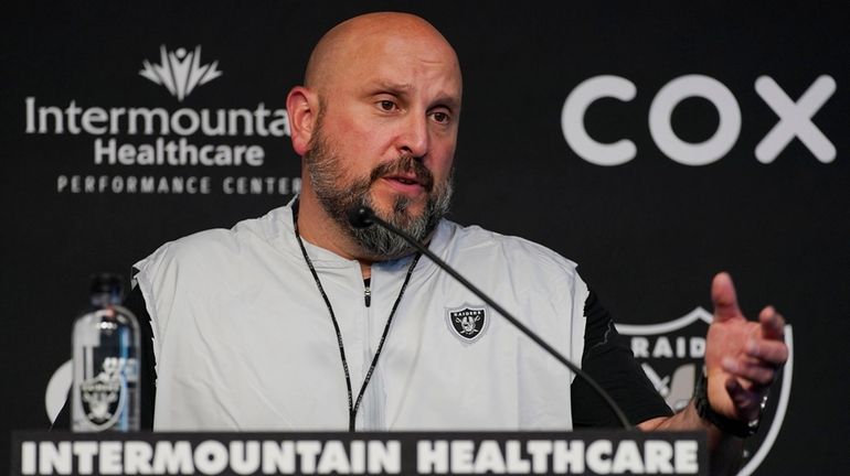 Then-Raiders offensive line coach Carmen Bricillo speaks during a news...