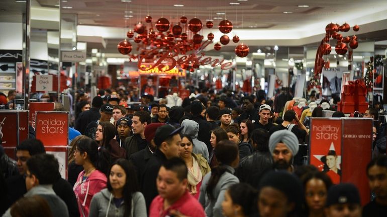 Shoppers flood into Macy's in the Roosevelt Field mall in...