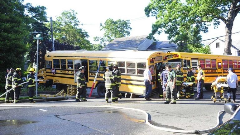 Two school buses, one of them carrying Chaminade High School...