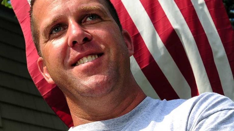 Portrait of Nassau County Police officer Mark Iovino in front...