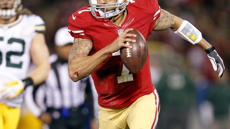 San Francisco 49ers quarterback Colin Kaepernick (7) runs for a...