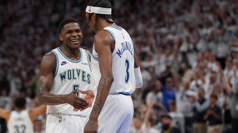 Minnesota Timberwolves forward Jaden McDaniels (3) celebrates with guard Anthony...