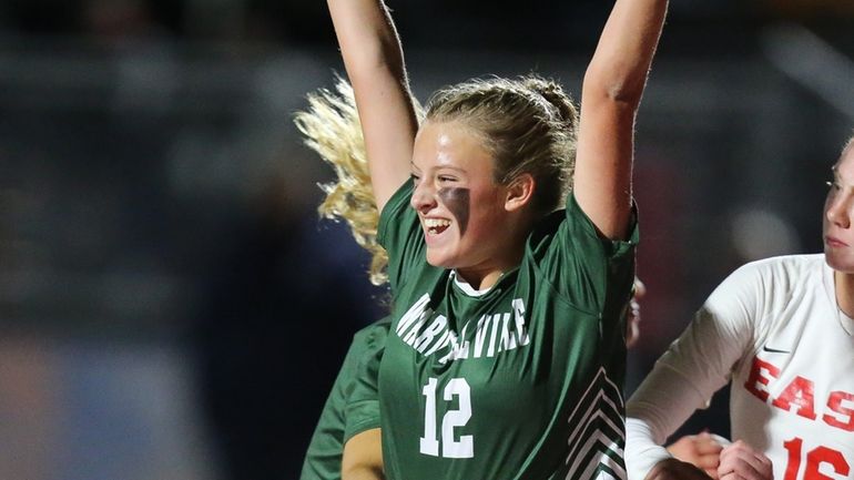 Ward Melville's Breena Harrigan (12) scores in the first half...