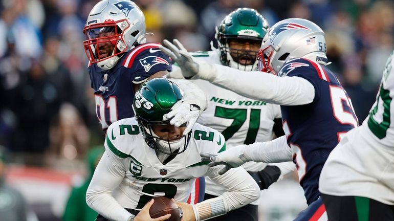 New York Jets quarterback Zach Wilson (2) is sacked by...