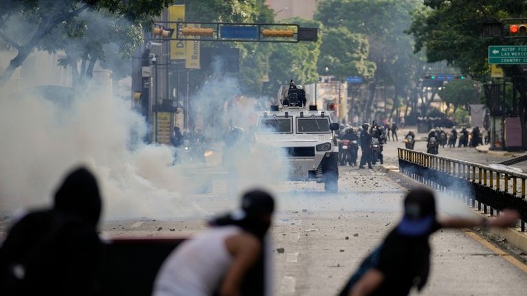 Protesters clash with police during demonstrations against the official election...