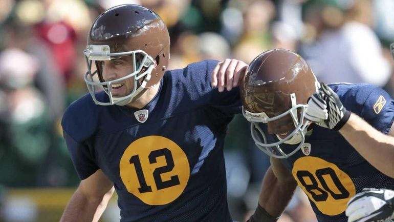 Green Bay Packers quarterback Aaron Rodgers (12) and teammate Donald...