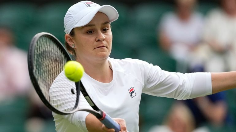 Australia's Ash Barty plays a forehand return during her invitation...