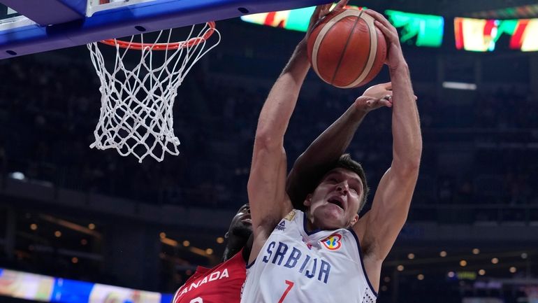 Canada guard Luguentz Dort, left, and Serbia guard Bogdan Bogdanovic...