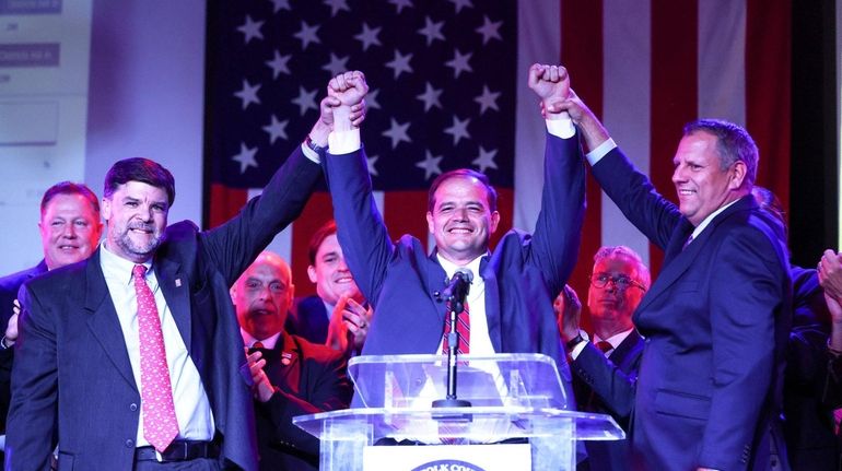 Ray Tierney, center, celebrates his win for Suffolk district attorney...