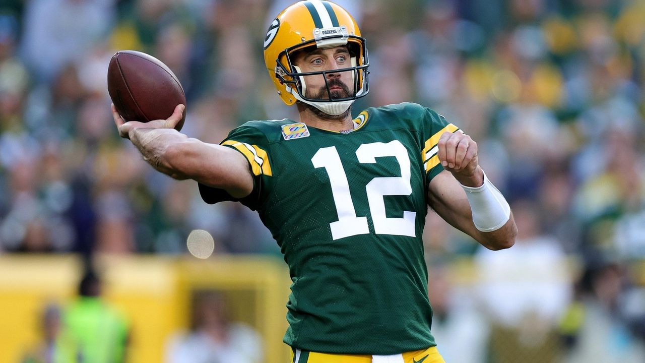 GREEN BAY, WI - OCTOBER 16: Green Bay Packers quarterback Aaron Rodgers  (12) drops to pass during a game between the Green Bay Packers and the New  York Jets at Lambeau Field