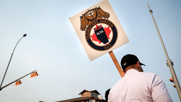 Teamsters Canada Rail Conference members picket outside the CPKC headquarters...