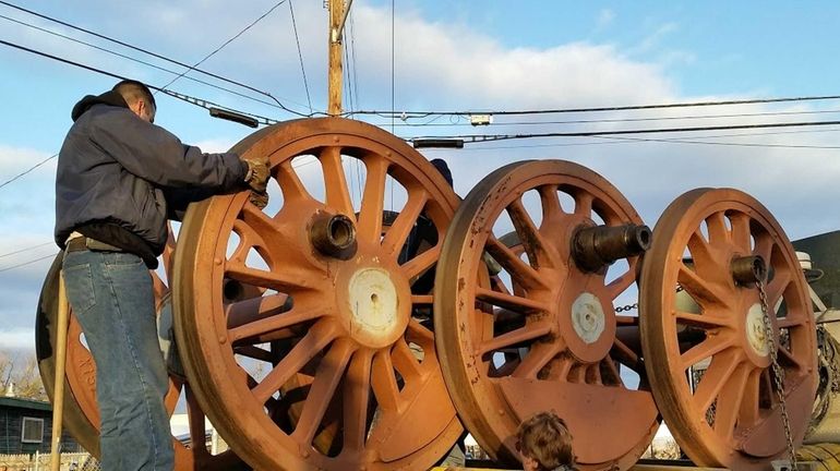 Volunteers from the Oyster Bay Railroad Museum load pieces of...