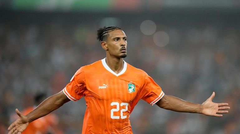 Ivory Coast's Sebastien Haller celebrates after scoring the opening goal...