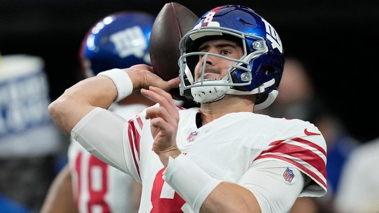 Giants quarterback Daniel Jones warms up before an NFL game against...