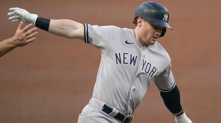 The Yankees' Clint Frazier is congratulated as he rounds the...