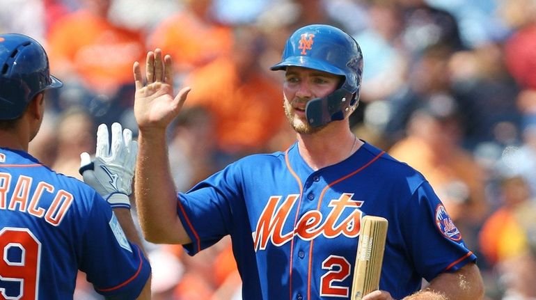 Pete Alonso #20 of the Mets is congratulated by Devin...