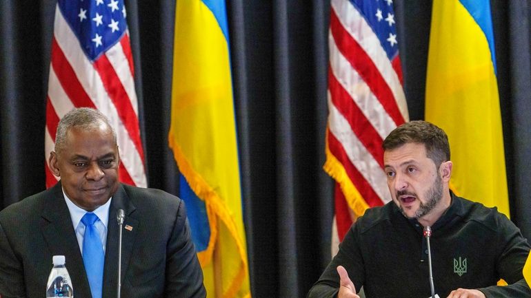 U.S. Defense Secretary Lloyd Austin, left, listens to Ukraine's President...