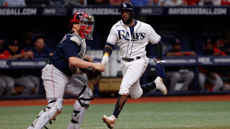 Tampa Bay Rays' Yandy Diaz, right, runs past Boston Red...