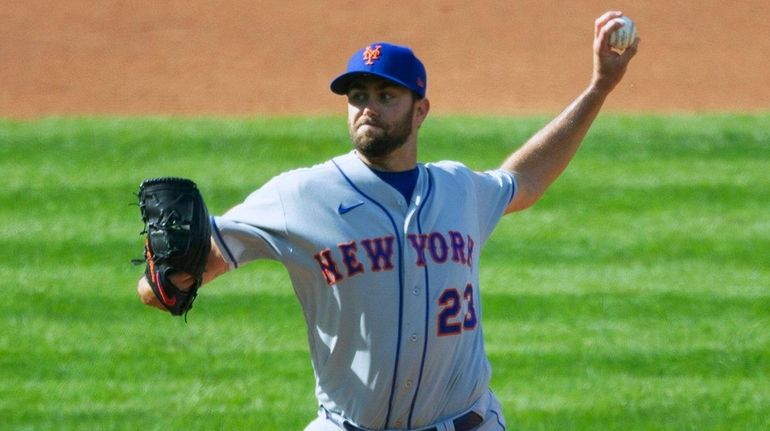 Mets starting pitcher David Peterson (23) throws during the first...