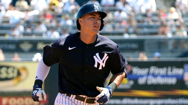 The Yankees' Anthony Volpe rounds the bases after hitting a...