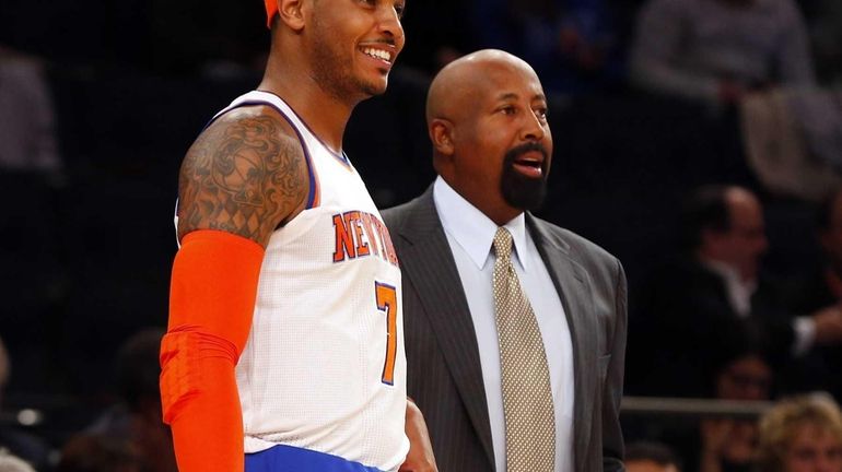 Carmelo Anthony and Mike Woodson look on during a game...