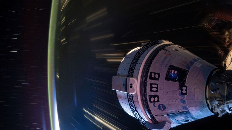 In this long-exposure photo provided by NASA, Boeing's Starliner spacecraft...