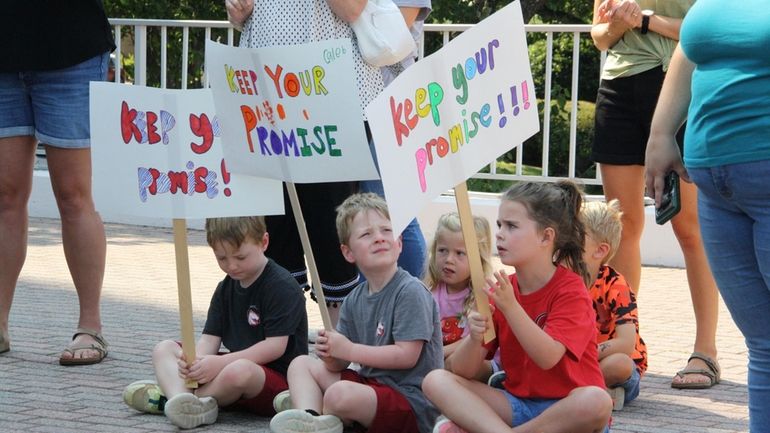 A group of children hold signs that say Keep Your...